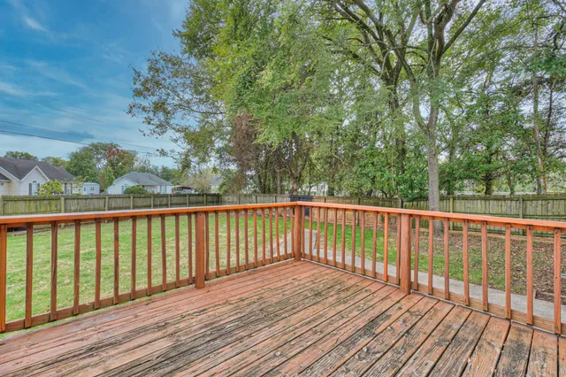 a balcony with wooden floor and fence