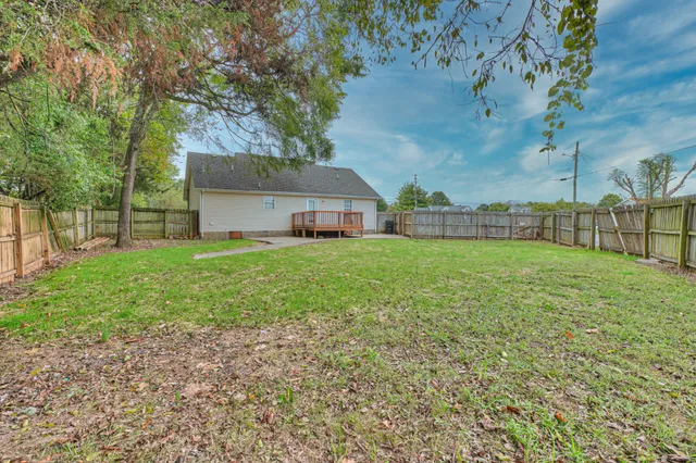 a view of a house with a yard and sitting area