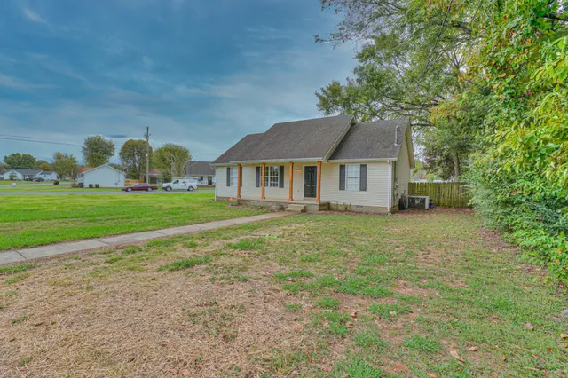 a house with huge green field in front of it