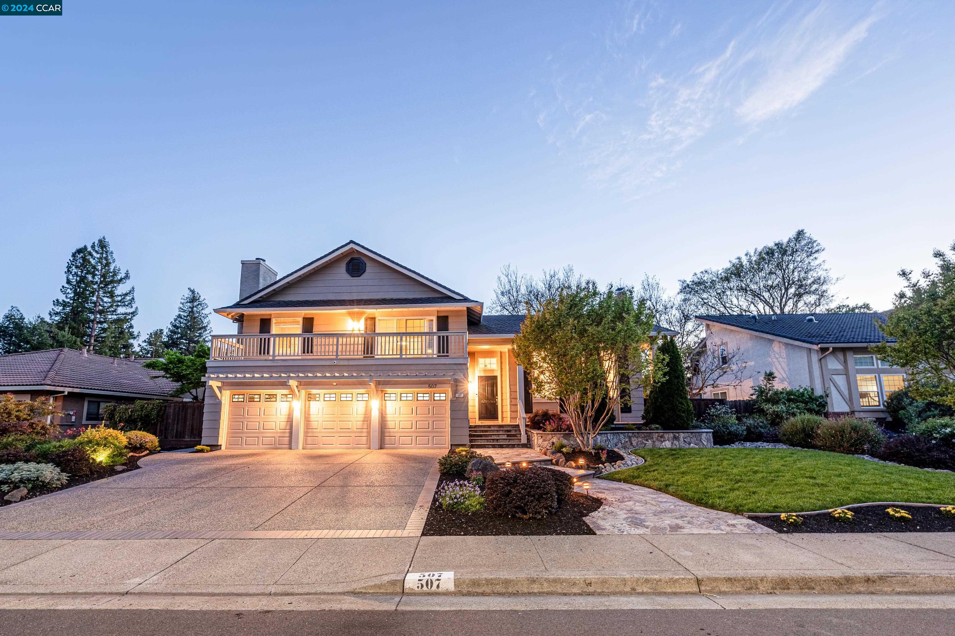 a front view of a house with a yard and garage