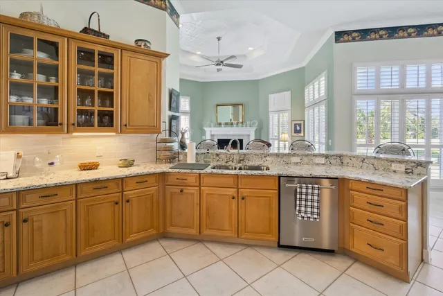 a kitchen with granite countertop cabinets sink and window