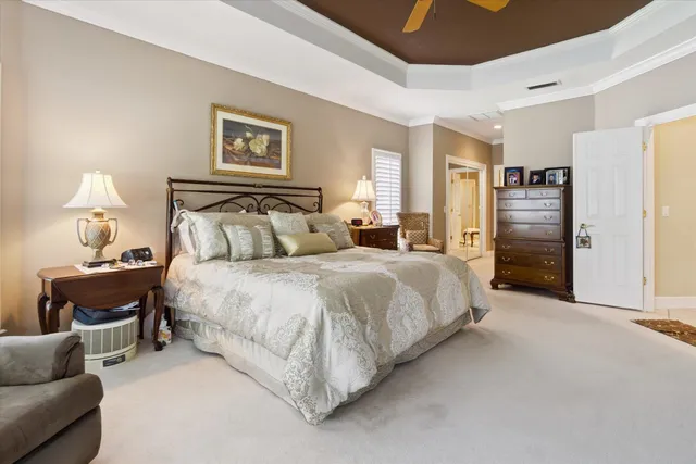 a bedroom with a bed and a dresser with mirror