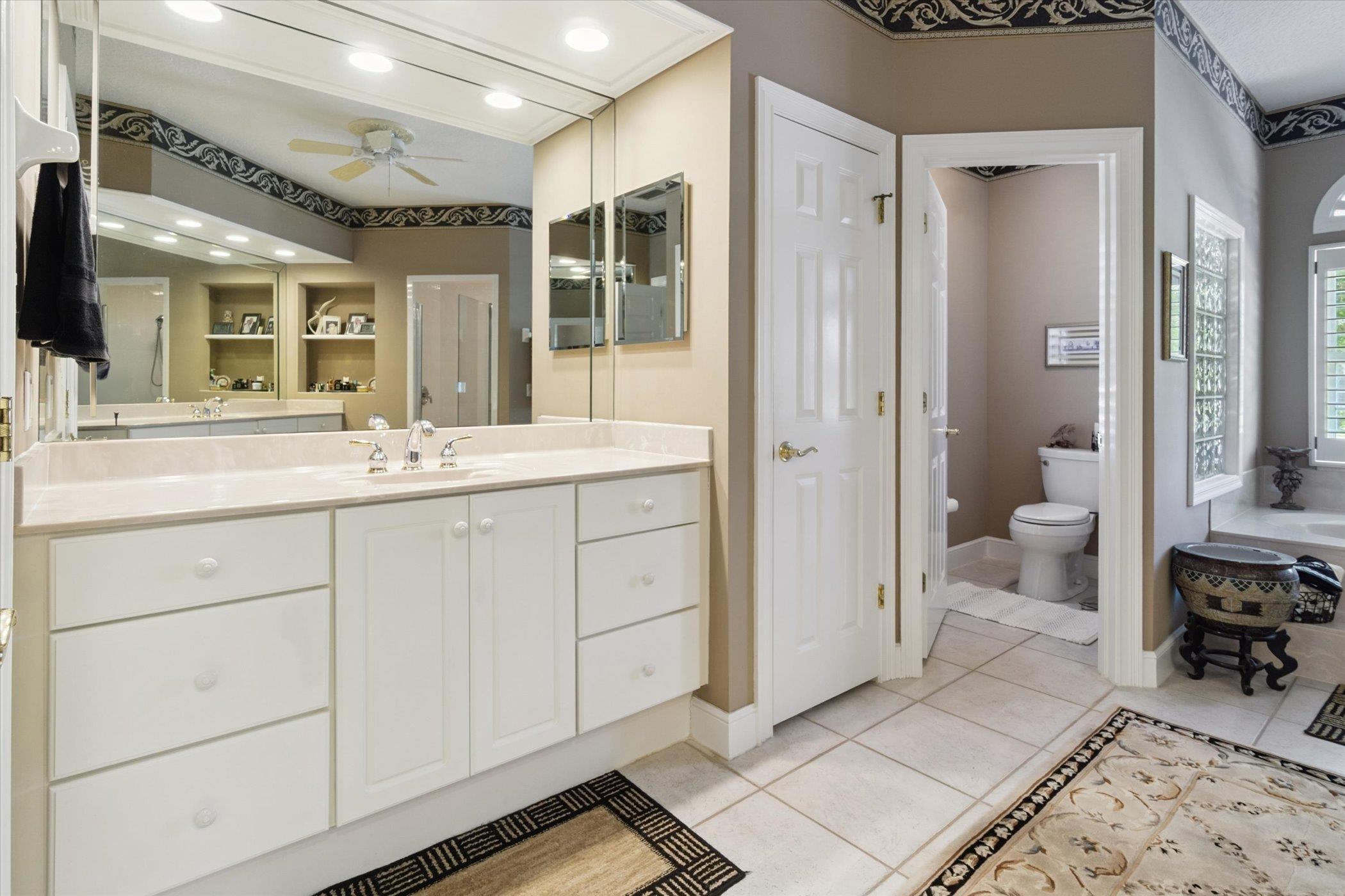 121 Marshside Drive St. Augustine, FL 32080 - Photo 32 of 71 a spacious bathroom with a double vanity sink a mirror and a shower