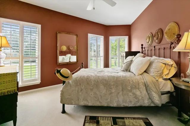 a living room with furniture and floor to ceiling windows