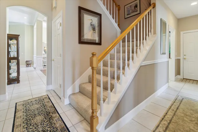 an aerial view of a house with a garden and lake view