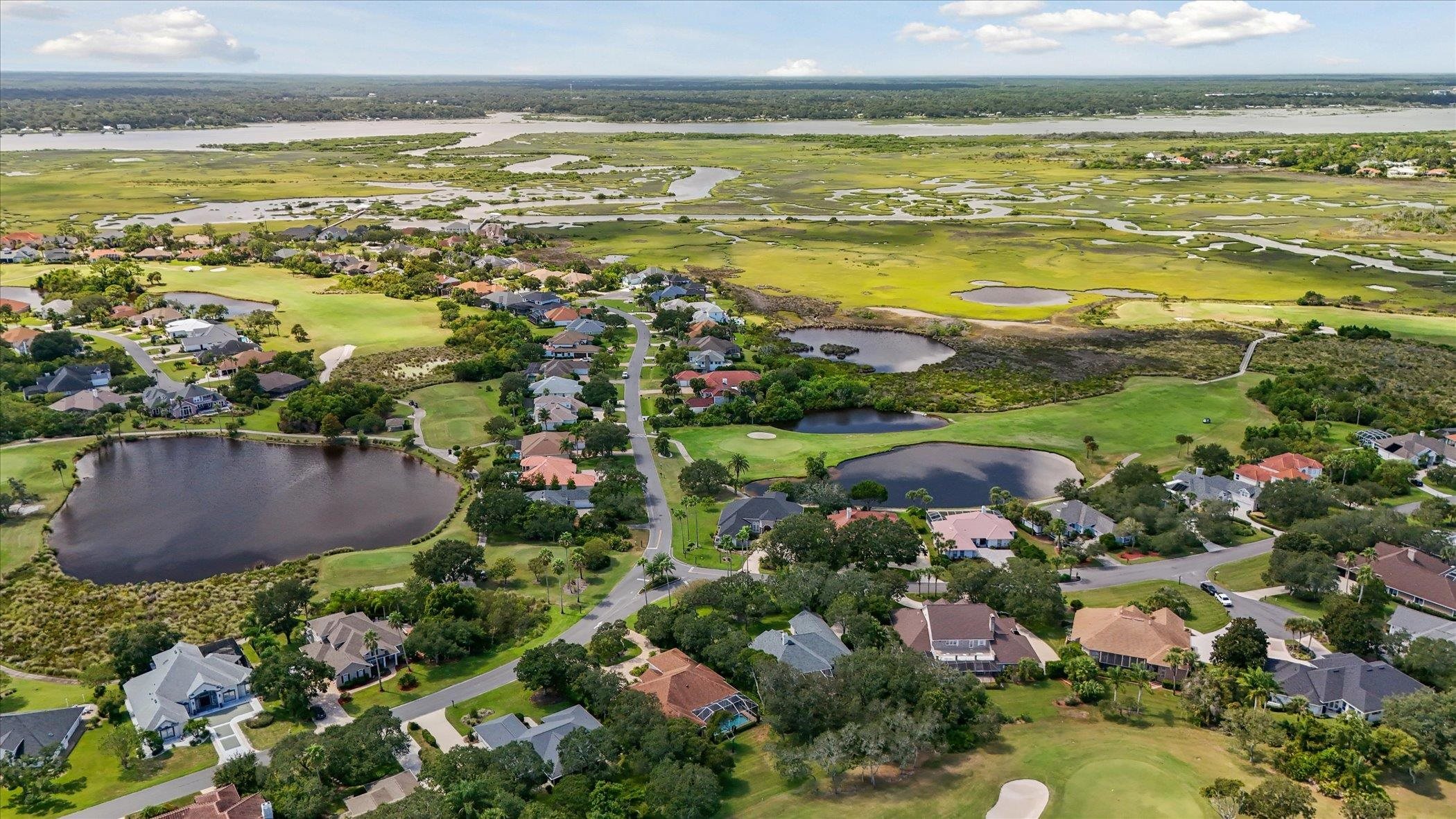 121 Marshside Drive St. Augustine, FL 32080 - Photo 66 of 71 Aerial view of property and surrounding area with a local golf course, nearby suburban area, and a large body of water