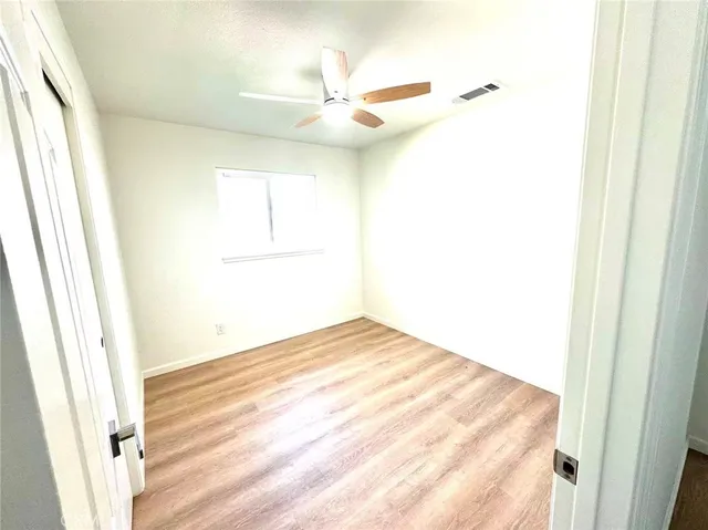 a view of a room with a ceiling fan