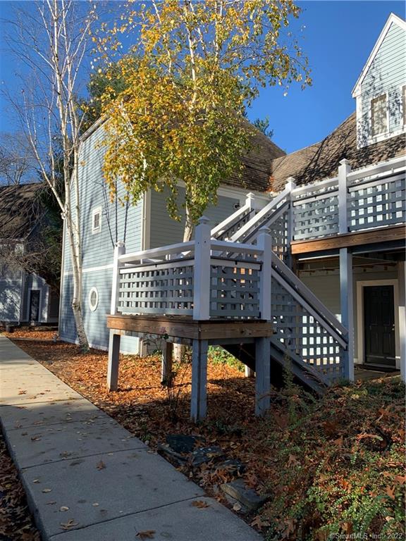 221 Old Pond Lane, Unit 221 Norwich, CT 06360 - Photo 1 of 1 a view of a roof deck with wooden fence and large trees