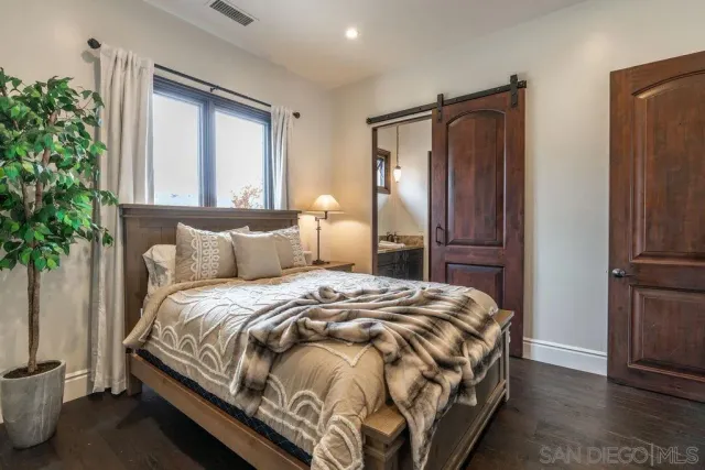 a bed room with a bed and a flat tv screen