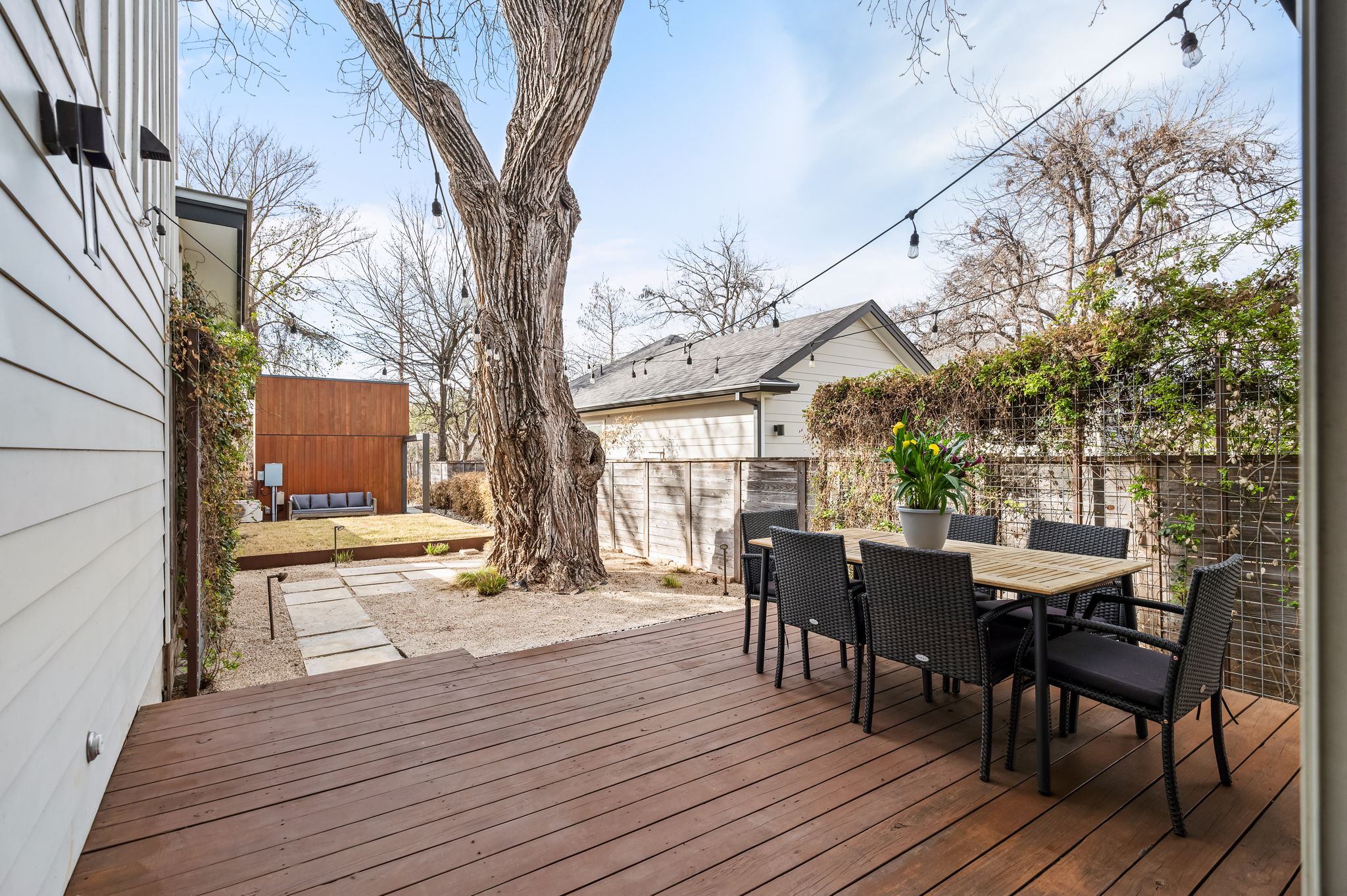 1124 Linden Street, Unit B Austin, TX 78702 - Photo 17 of 26 Wooden terrace featuring outdoor dining area and a fenced backyard