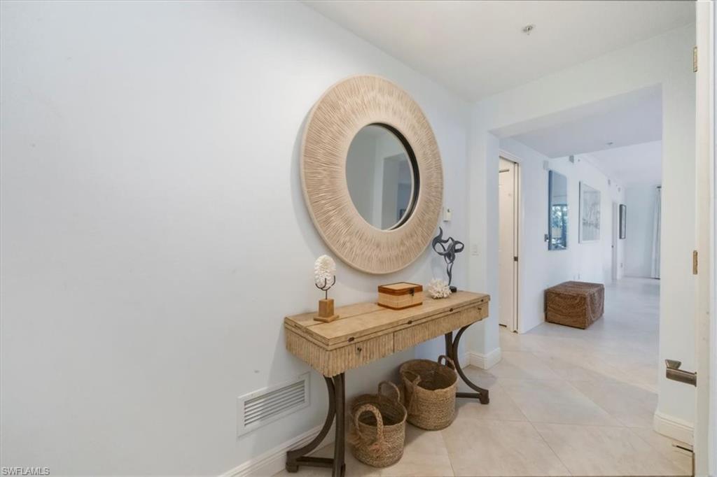 965 Sandpiper Street, Unit J107 Naples, FL 34102 - Photo 2 of 29 a view of a room with a table and chairs