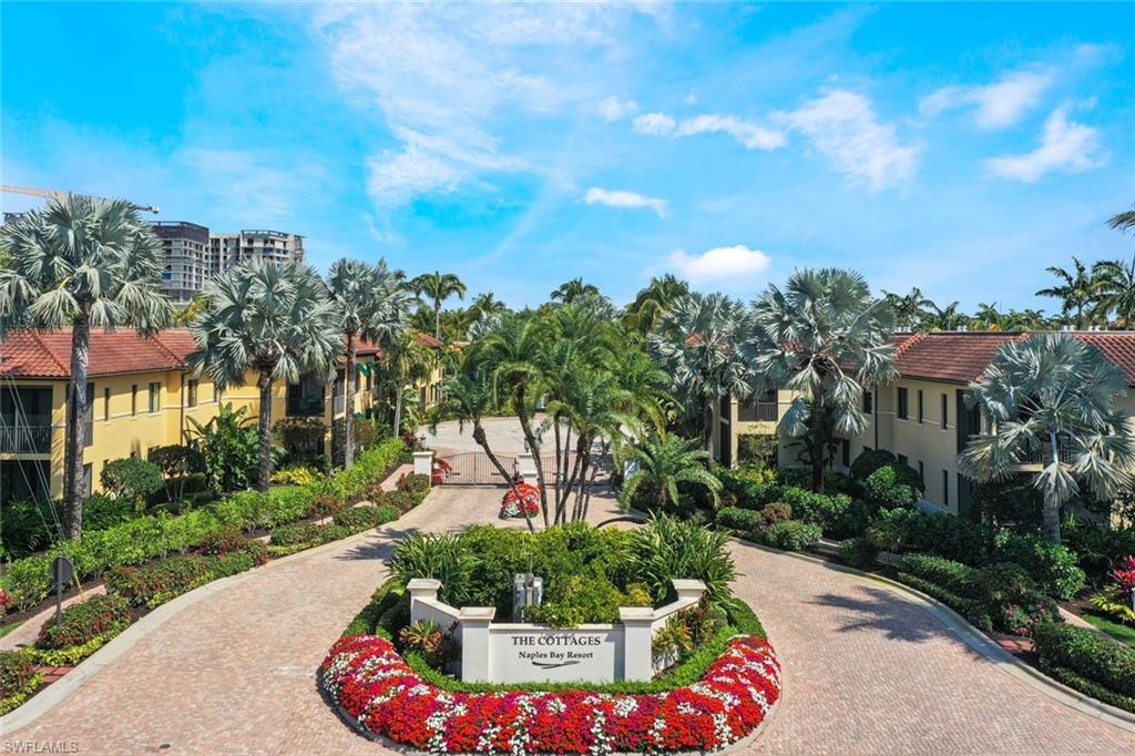 965 Sandpiper Street, Unit J107 Naples, FL 34102 - Photo 23 of 29 a view of a garden with a building in the background