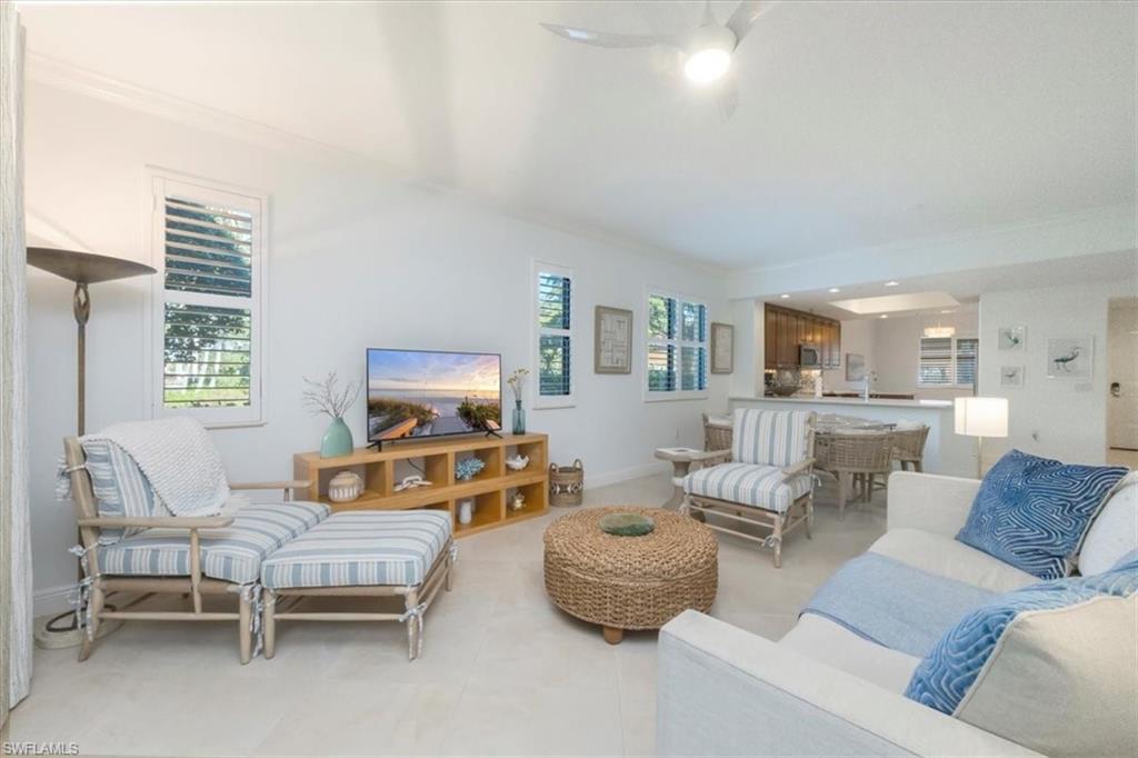 965 Sandpiper Street, Unit J107 Naples, FL 34102 - Photo 5 of 29 a living room with furniture and a window