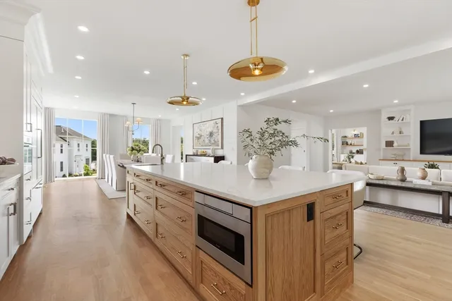 a kitchen with stainless steel appliances kitchen island a large island in the center