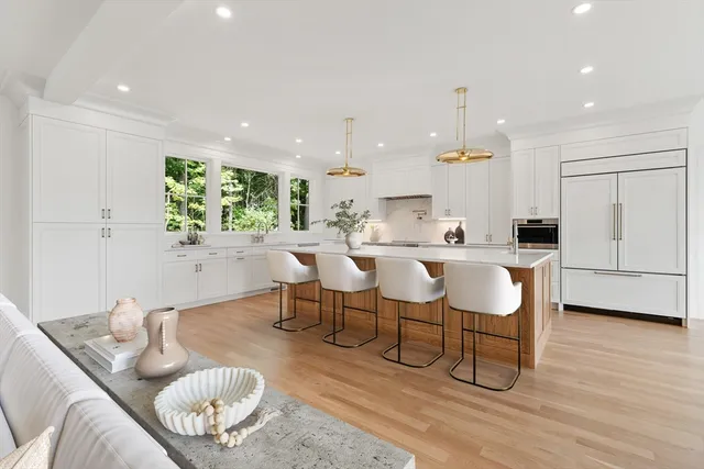 a living room with furniture kitchen and a table