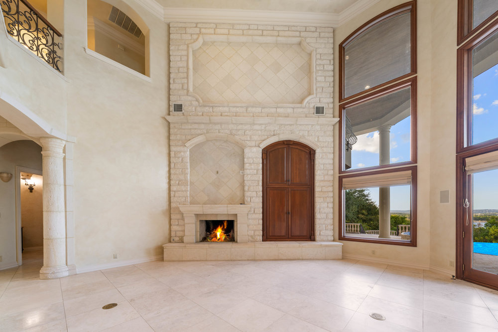 217 Bella Riva Drive Austin, TX 78734 - Photo 12 of 36 an empty room with windows fireplace and windows
