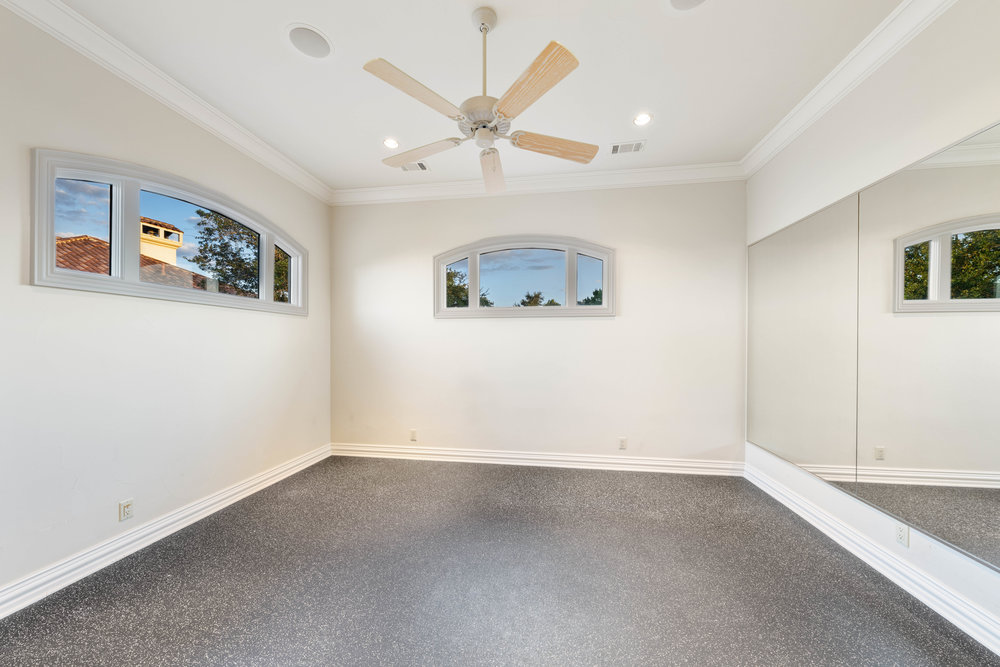 217 Bella Riva Drive Austin, TX 78734 - Photo 25 of 36 an empty room with a ceiling fan and window