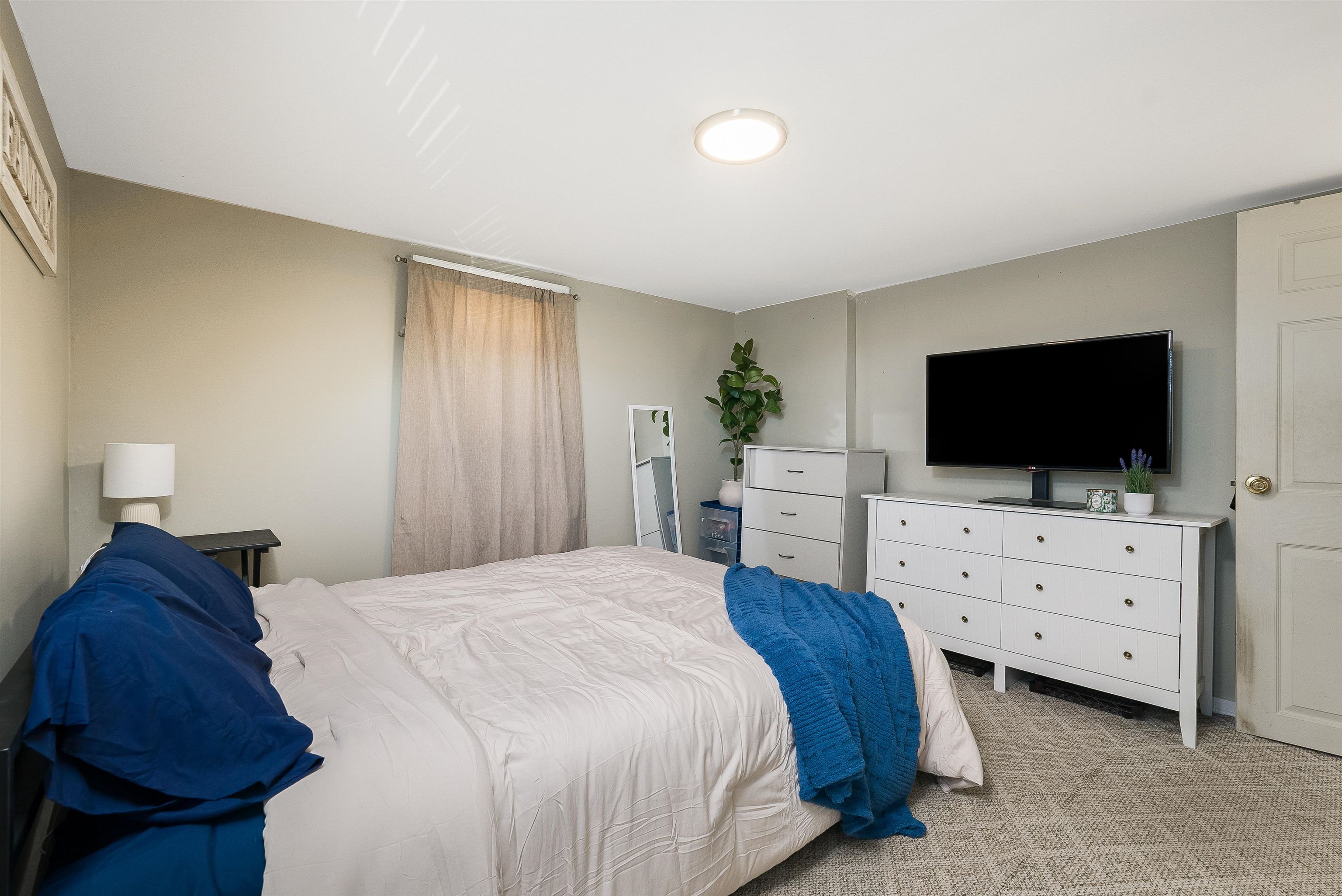 806 Randolph Street Staunton, VA 24401 - Photo 14 of 25 a bedroom with a bed and flat screen tv