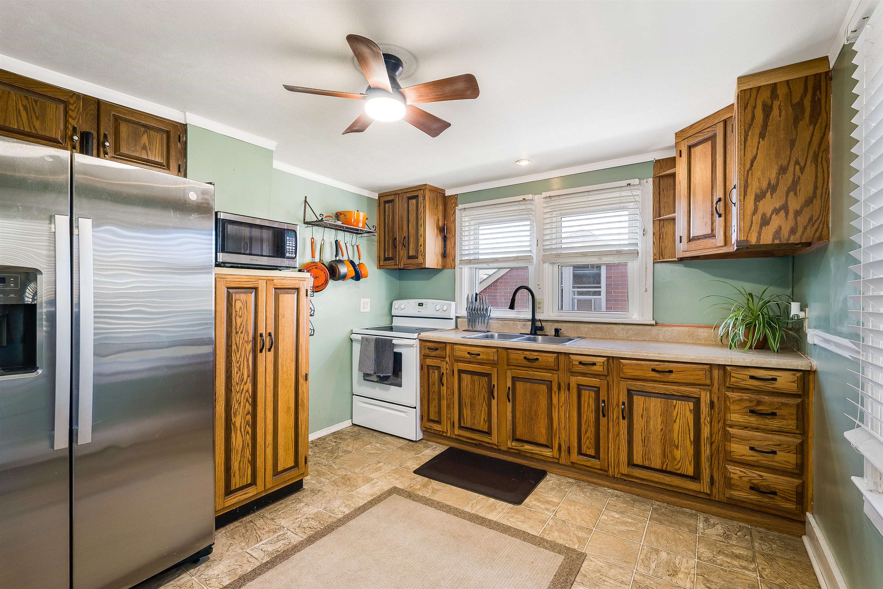 806 Randolph Street Staunton, VA 24401 - Photo 8 of 25 a kitchen with stainless steel appliances granite countertop a refrigerator a oven a sink with island and chairs