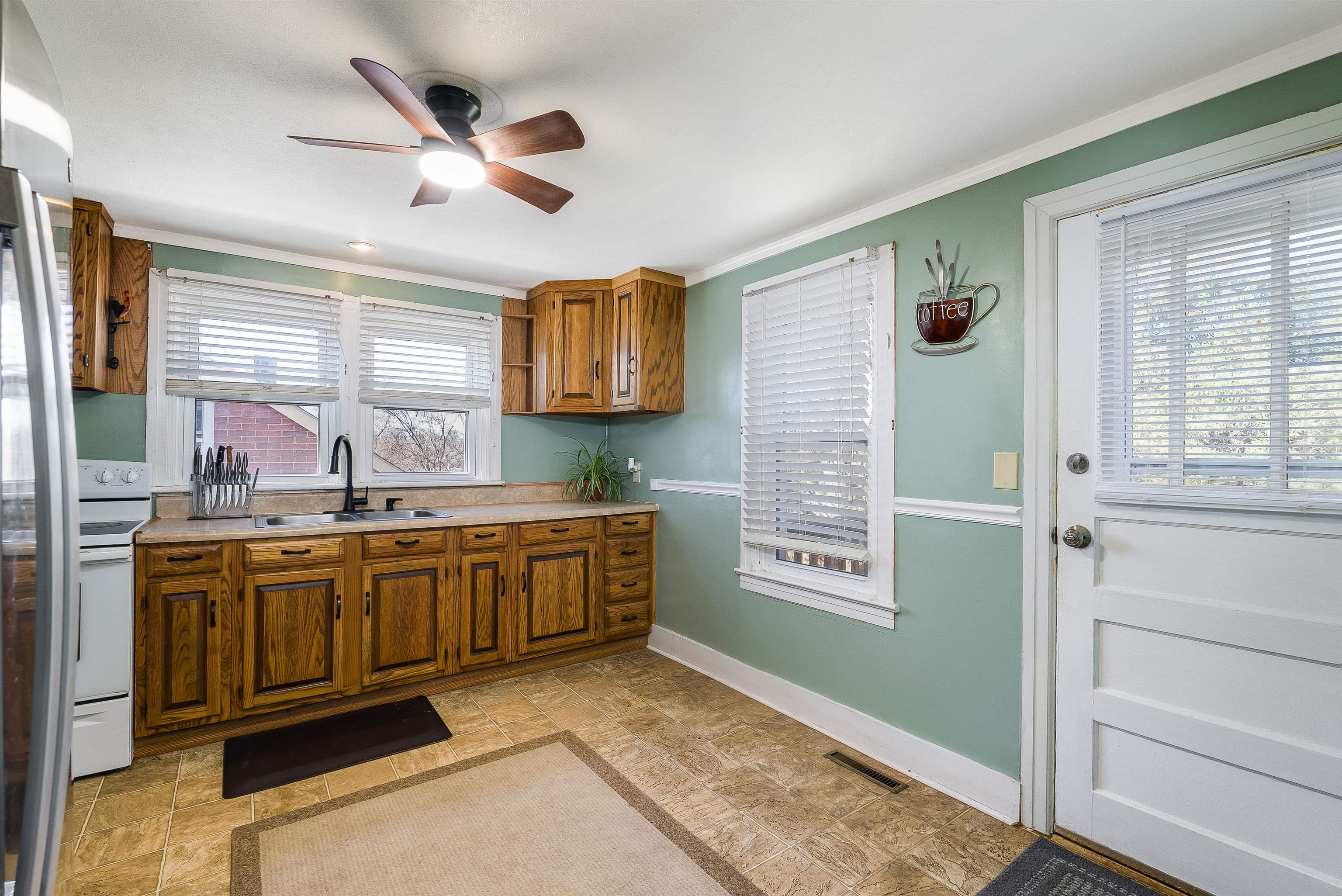 806 Randolph Street Staunton, VA 24401 - Photo 9 of 25 a kitchen with stainless steel appliances granite countertop a sink and a stove next to a window