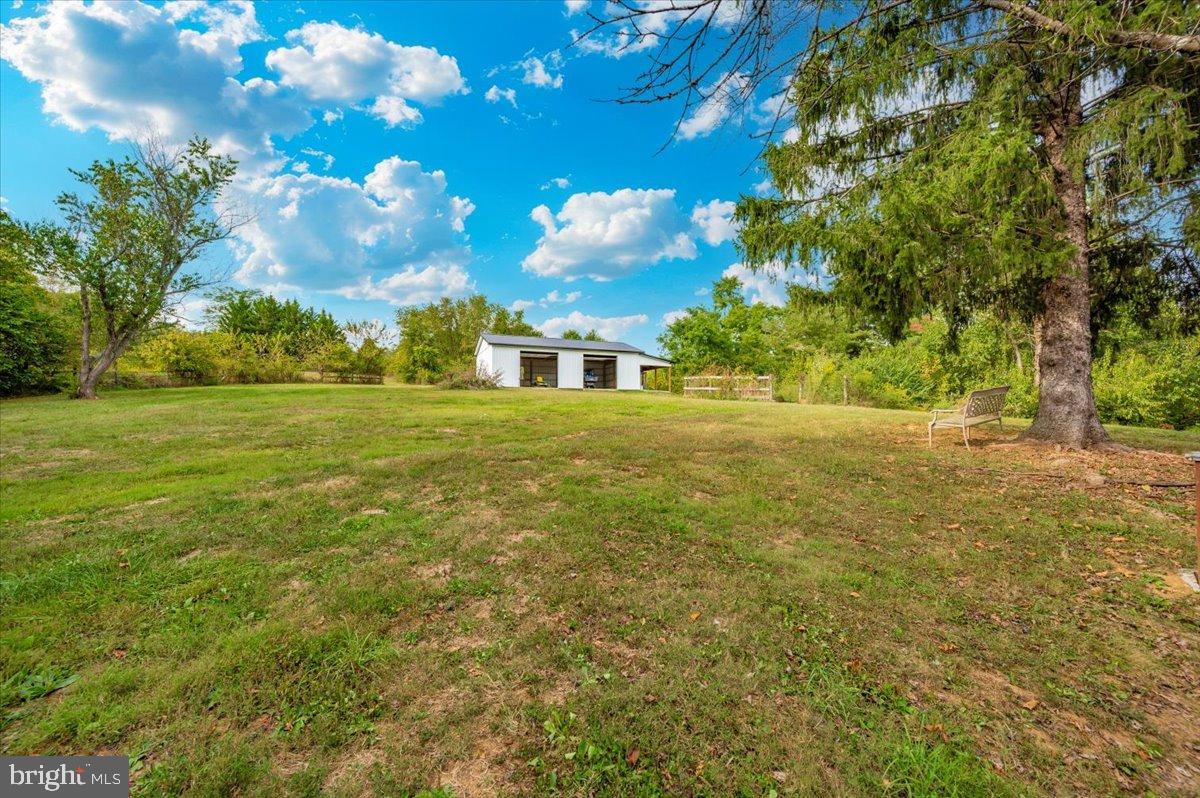 2710 Monument Road Myersville, MD 21773 - Photo 56 of 79 Spacious yard under a vibrant blue sky.
