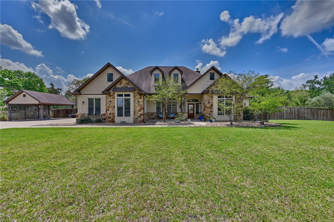 a front view of house with yard and outdoor seating