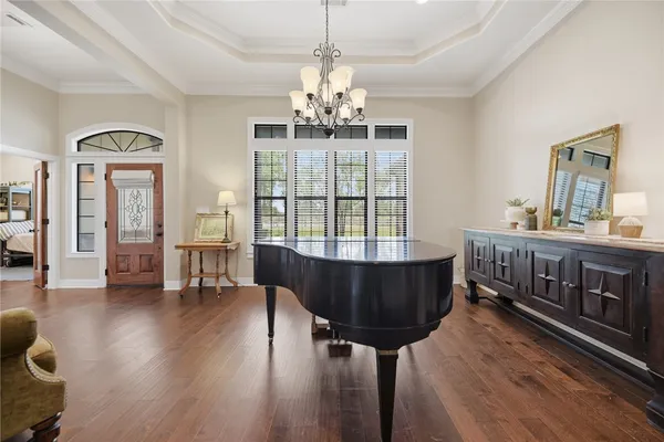 a living room with furniture a fireplace and a chandelier
