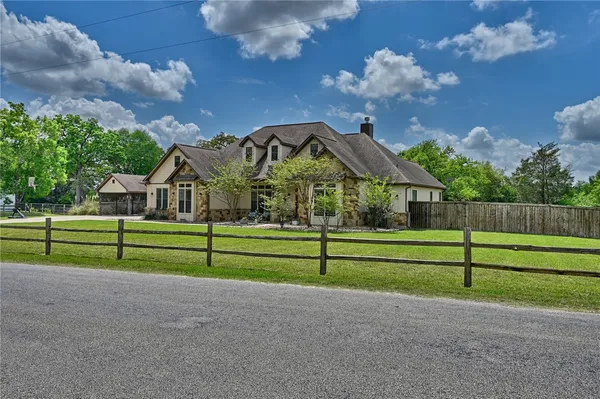 a front view of house with yard and outdoor seating