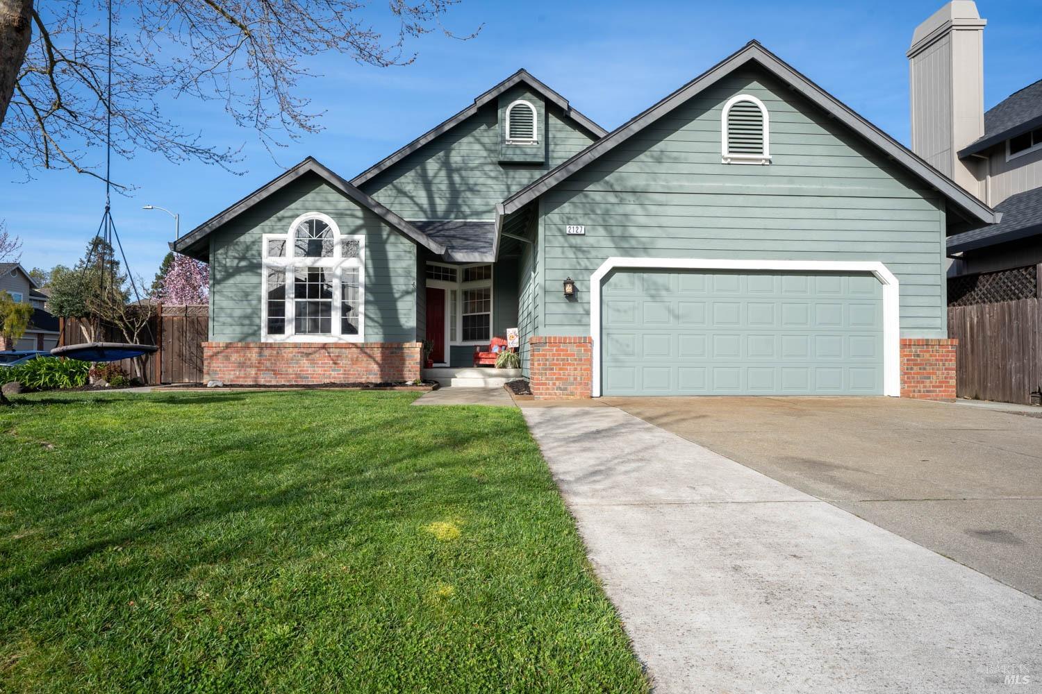 2127 Bock Street Santa Rosa, CA 95403 - Photo 1 of 1 a front view of a house with a yard and garage