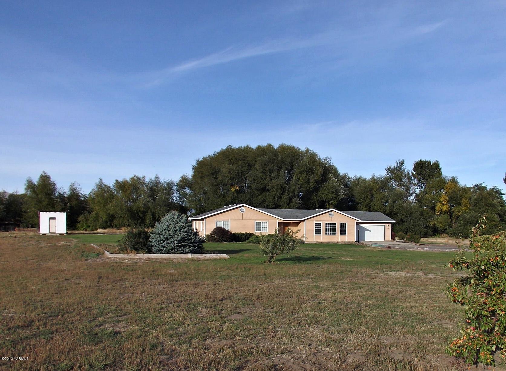 a view of a big house with a yard