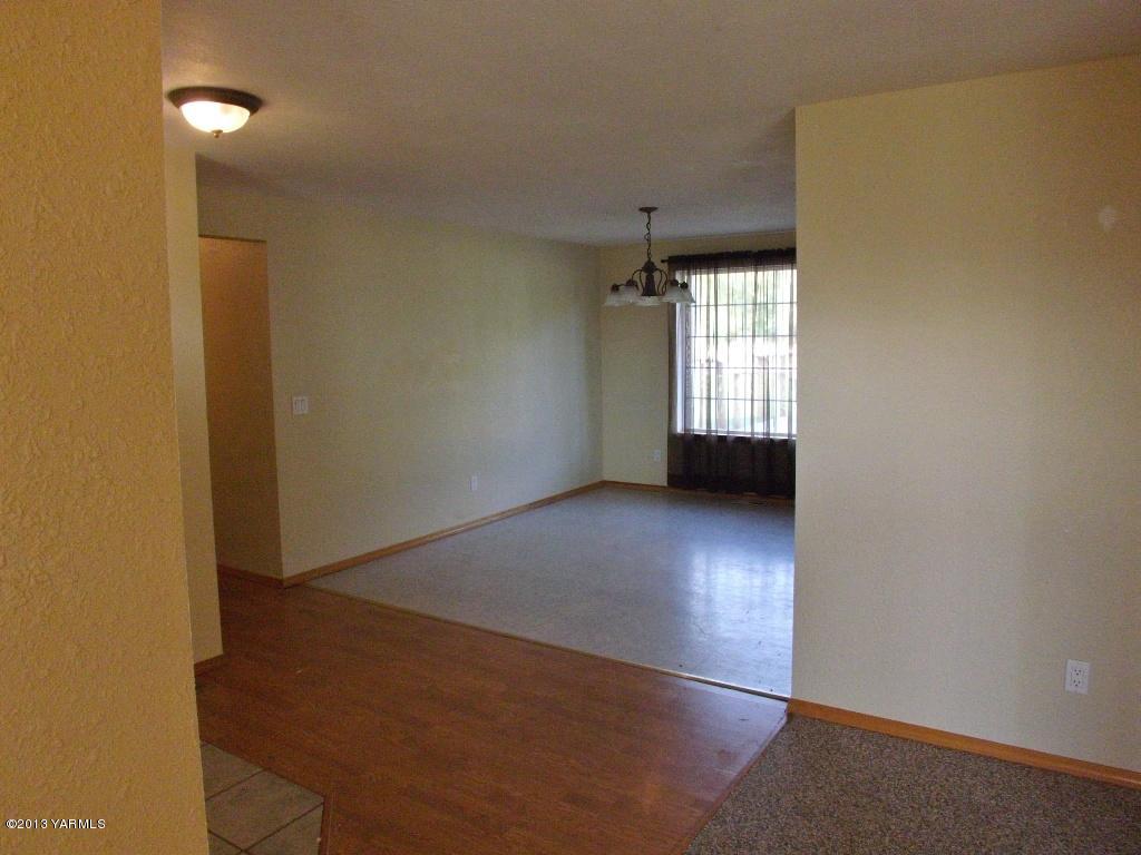 17481 Summitview Road Cowiche, WA 98923 - Photo 3 of 12 an empty room with wooden floor and windows