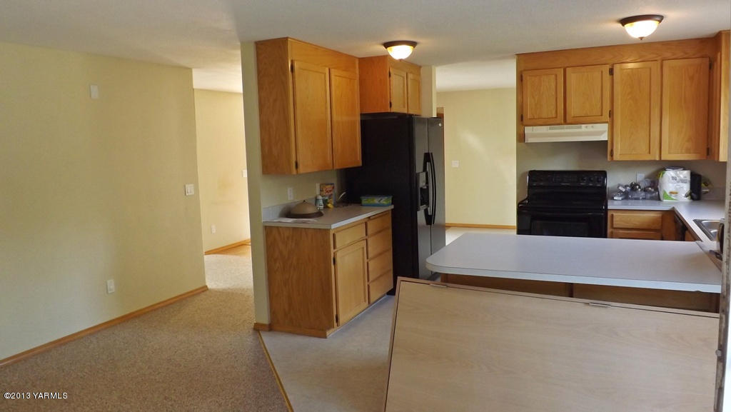 17481 Summitview Road Cowiche, WA 98923 - Photo 4 of 12 a kitchen with stainless steel appliances a refrigerator a stove a sink and a cabinets