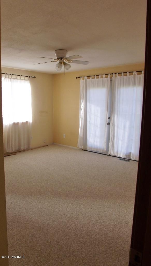 17481 Summitview Road Cowiche, WA 98923 - Photo 8 of 12 en empty room with windows and fan