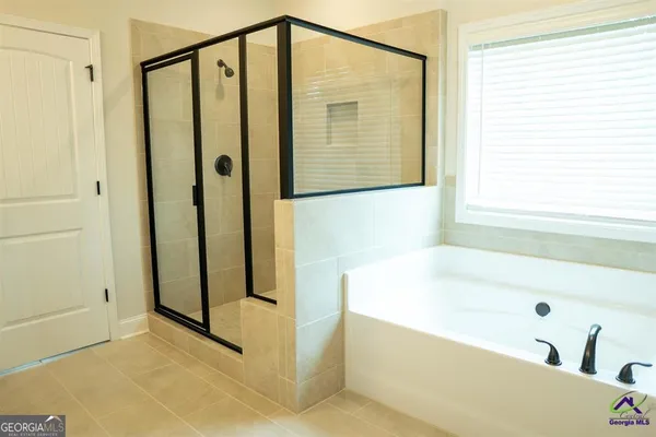a bathroom with a bathtub and a shower