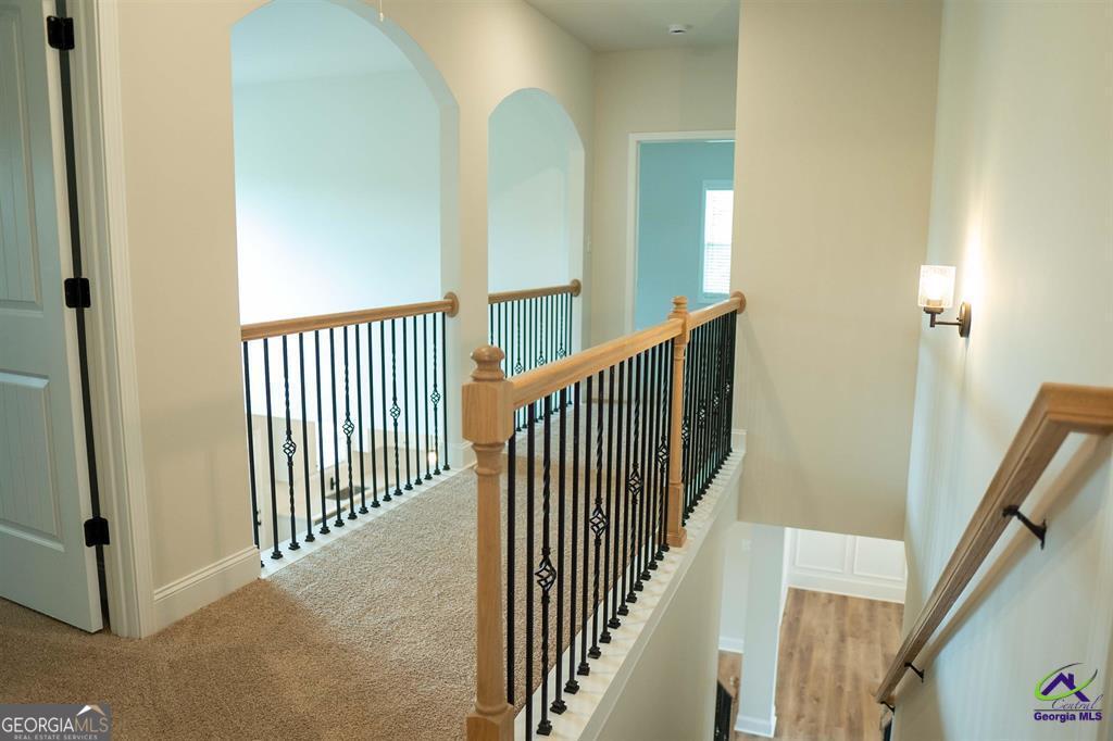119 Bluecoat Trail Byron, GA 31008 - Photo 18 of 37 a view of a hallway with wooden floor and stairs