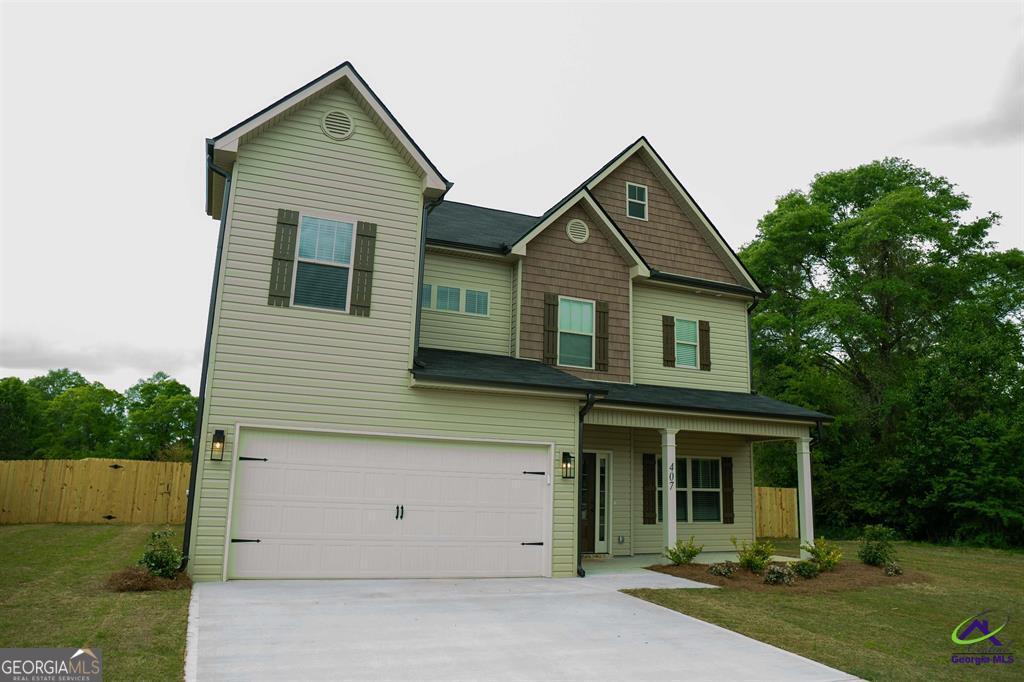 119 Bluecoat Trail Byron, GA 31008 - Photo 2 of 37 a front view of a house with a yard and garage