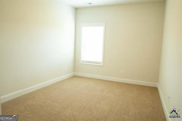 a large kitchen with stainless steel appliances granite countertop a sink and a refrigerator