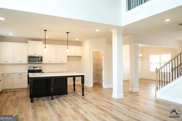 a view of an empty room with wooden floor