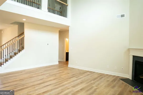 a kitchen with white cabinets and sink