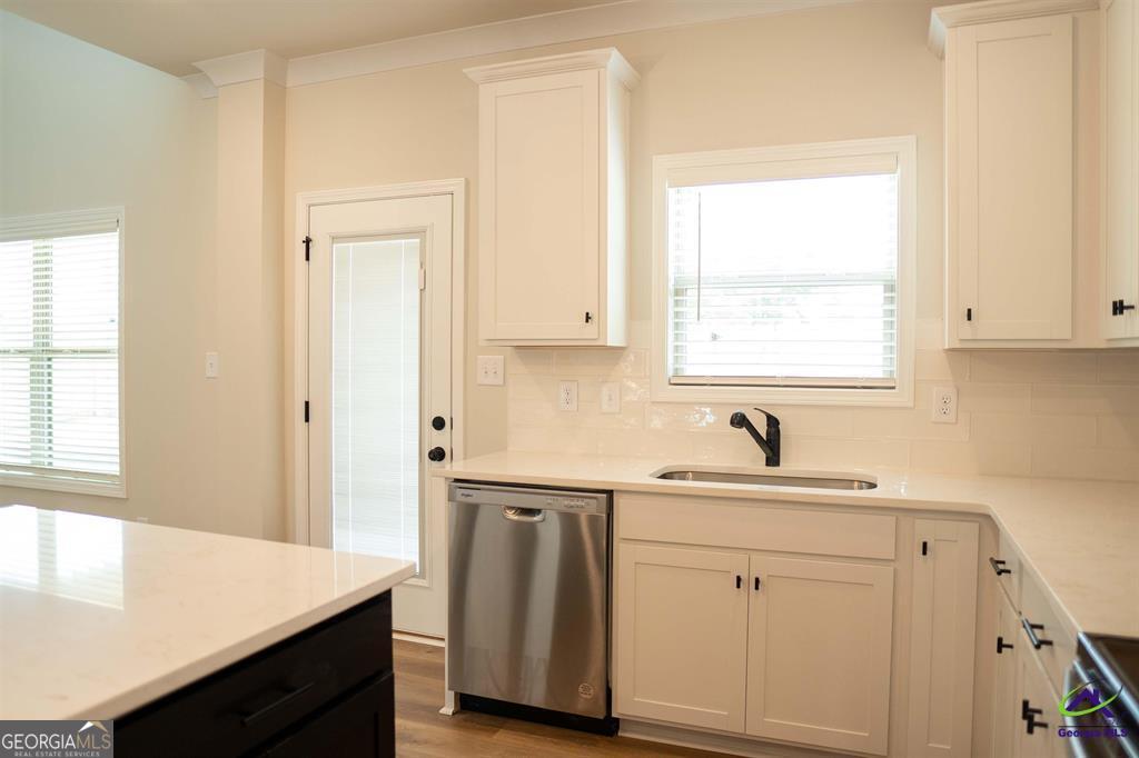 119 Bluecoat Trail Byron, GA 31008 - Photo 26 of 37 a kitchen with white cabinets and sink