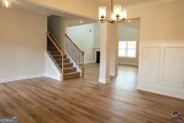 a view of an entryway with wooden floor