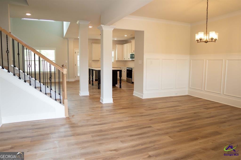 119 Bluecoat Trail Byron, GA 31008 - Photo 33 of 37 a view of a room with wooden floor and staircase
