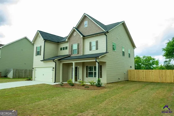 a view of a yard in front of a house with garage