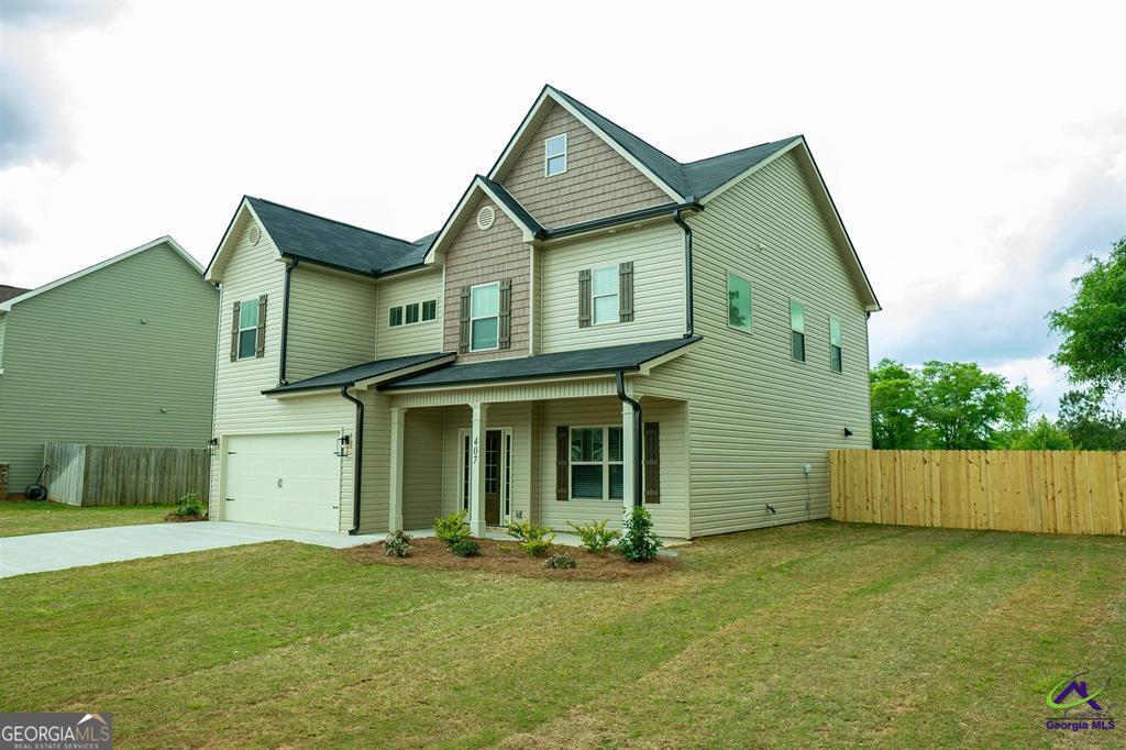 119 Bluecoat Trail Byron, GA 31008 - Photo 4 of 37 a view of a yard in front of a house with garage