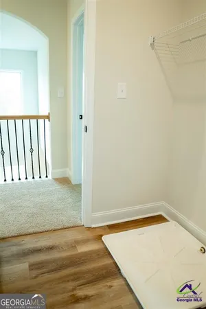 a view of a room with wooden floor