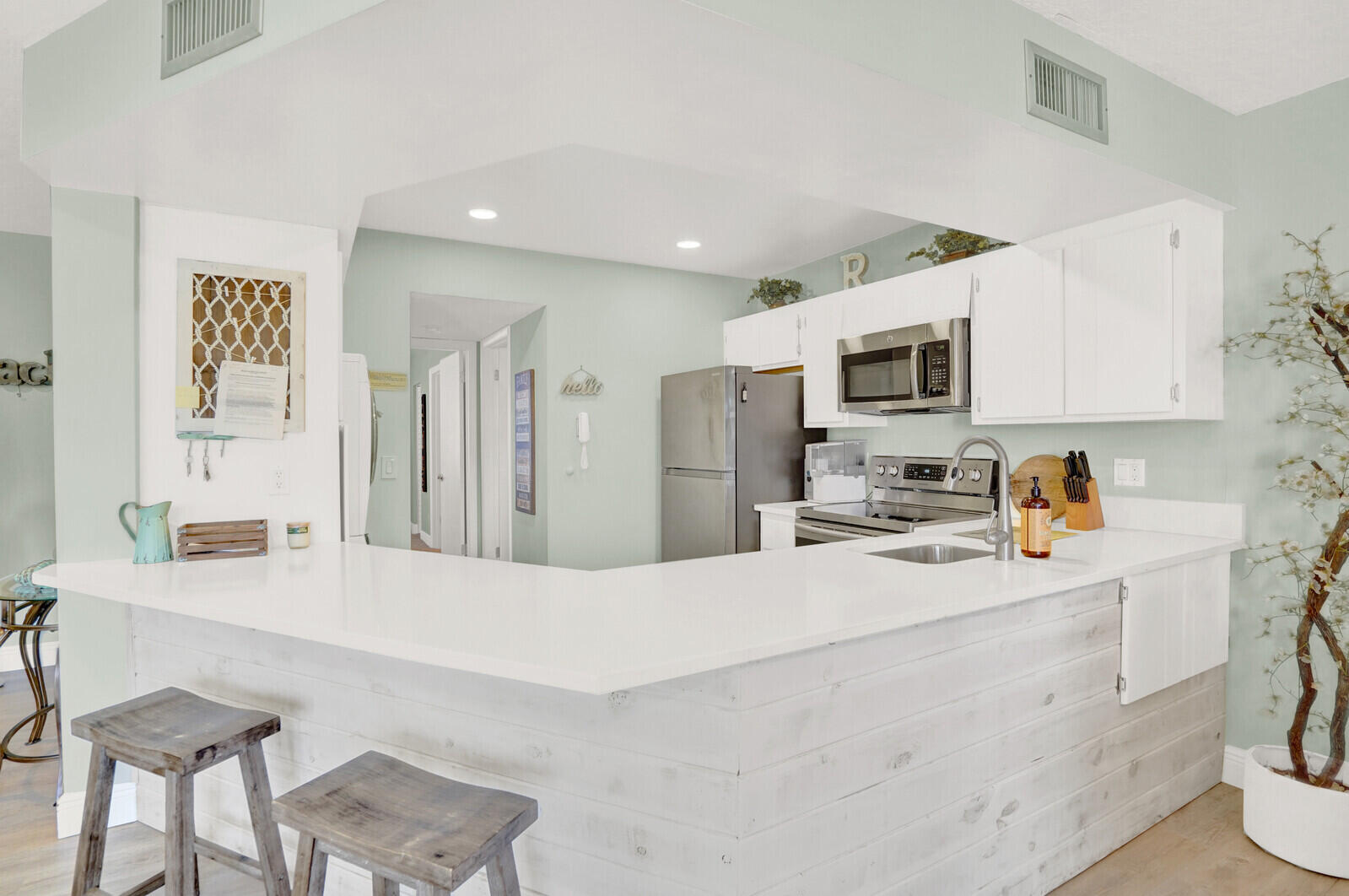 1605 Highway 1, Unit 202V5 Jupiter, FL 33477 - Photo 11 of 26 a kitchen with kitchen island a sink stove and refrigerator