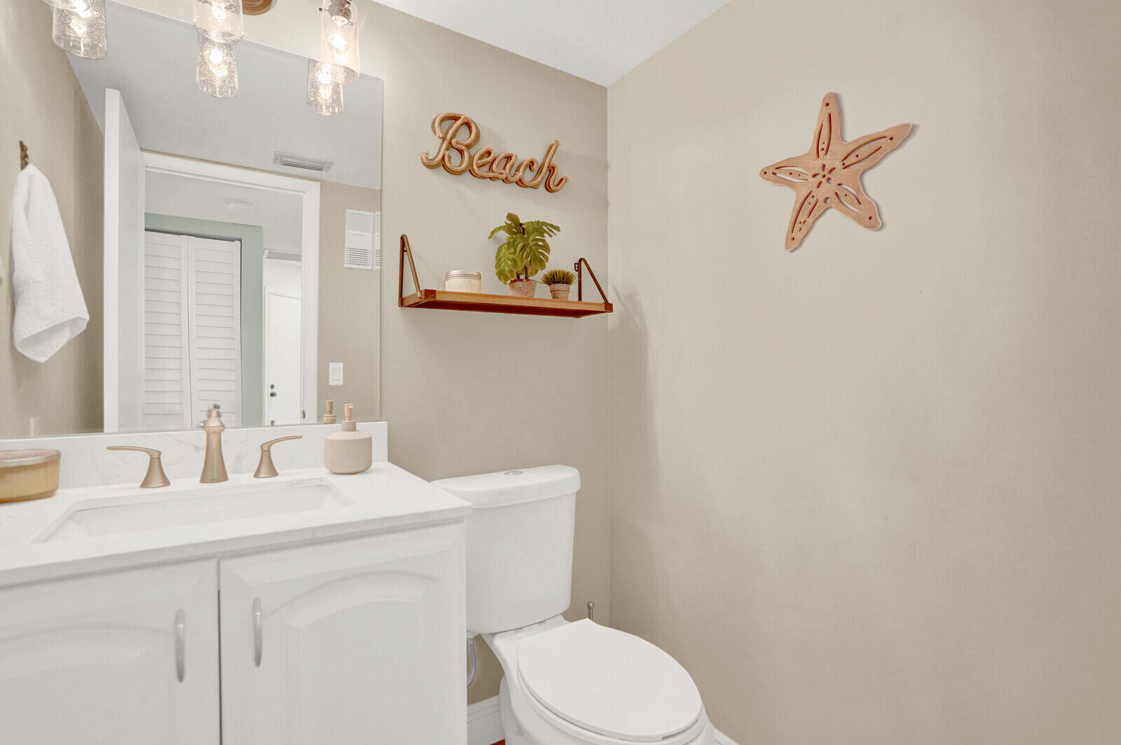 1605 Highway 1, Unit 202V5 Jupiter, FL 33477 - Photo 13 of 26 a bathroom with a sink mirror vanity and toilet