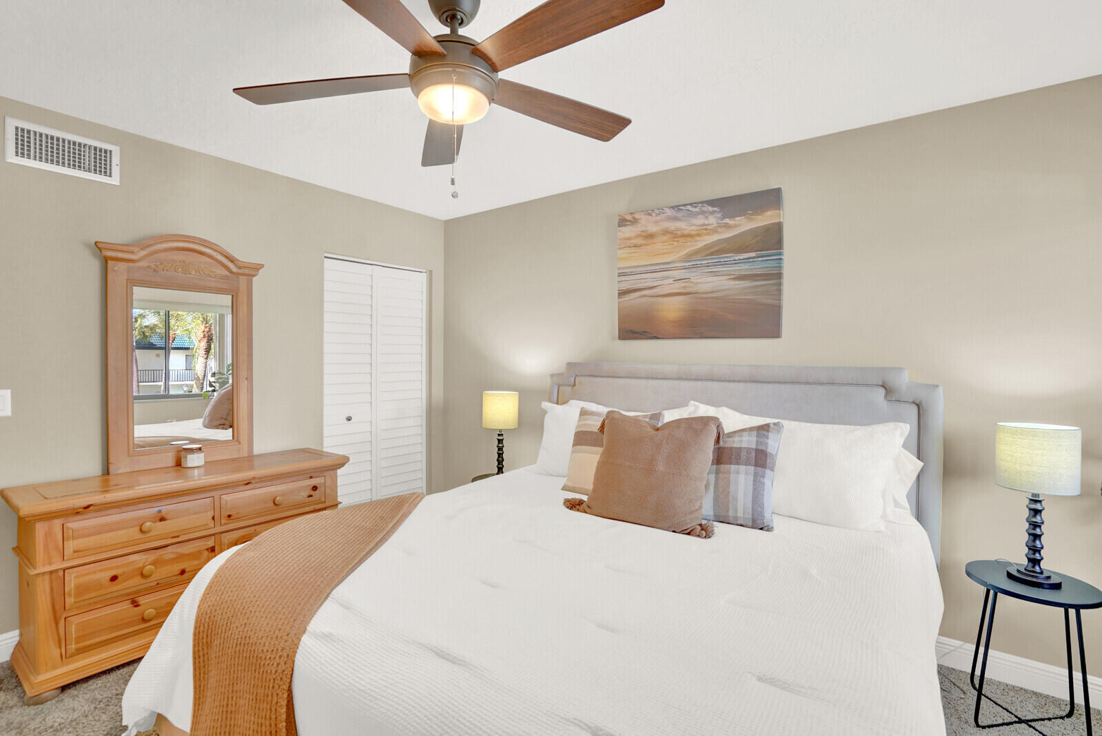 1605 Highway 1, Unit 202V5 Jupiter, FL 33477 - Photo 16 of 26 a bedroom with a bed and a chandelier