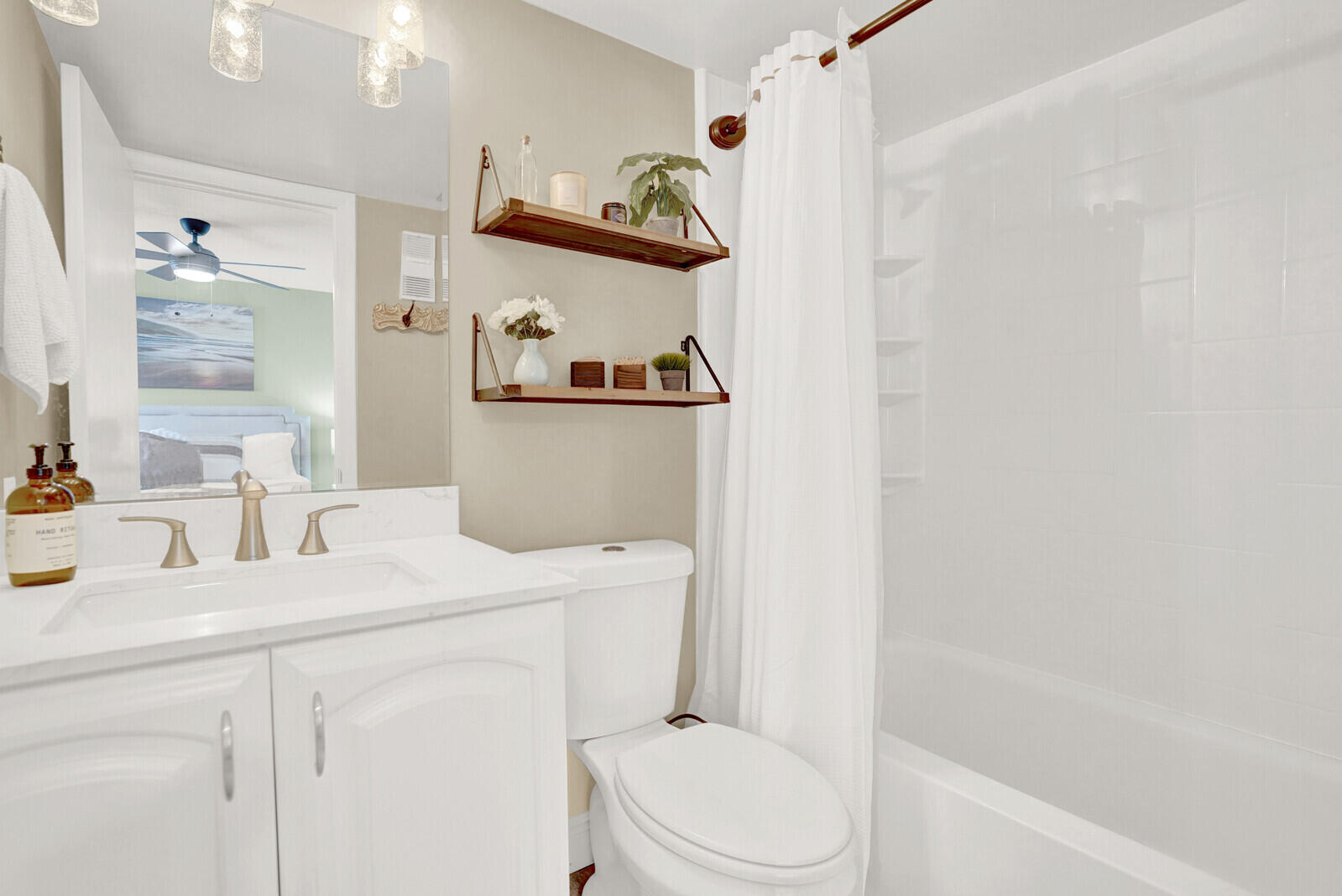 1605 Highway 1, Unit 202V5 Jupiter, FL 33477 - Photo 17 of 26 a bathroom with a sink a toilet and a mirror