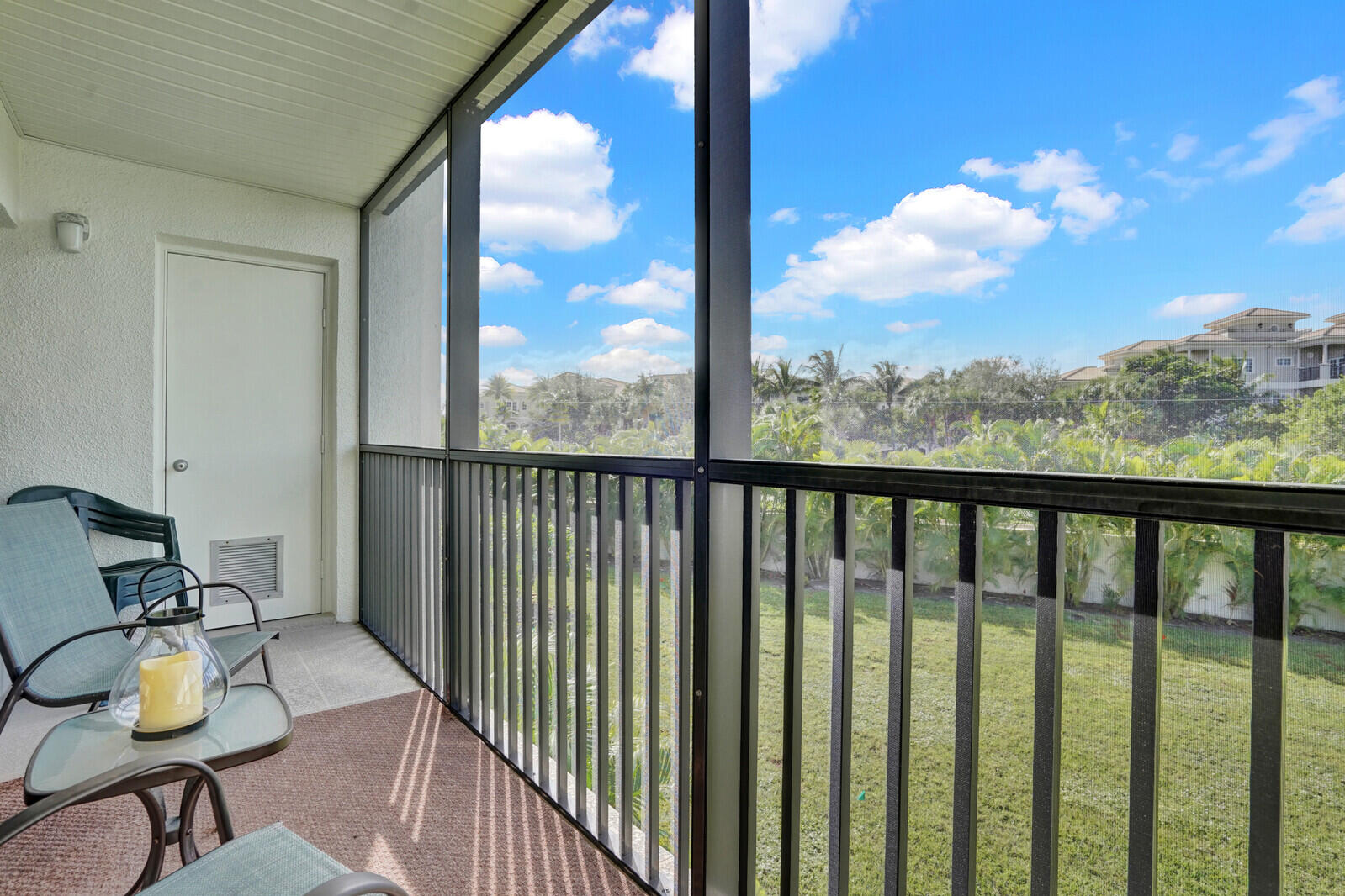 1605 Highway 1, Unit 202V5 Jupiter, FL 33477 - Photo 19 of 26 a view of a balcony with chair and wooden floor